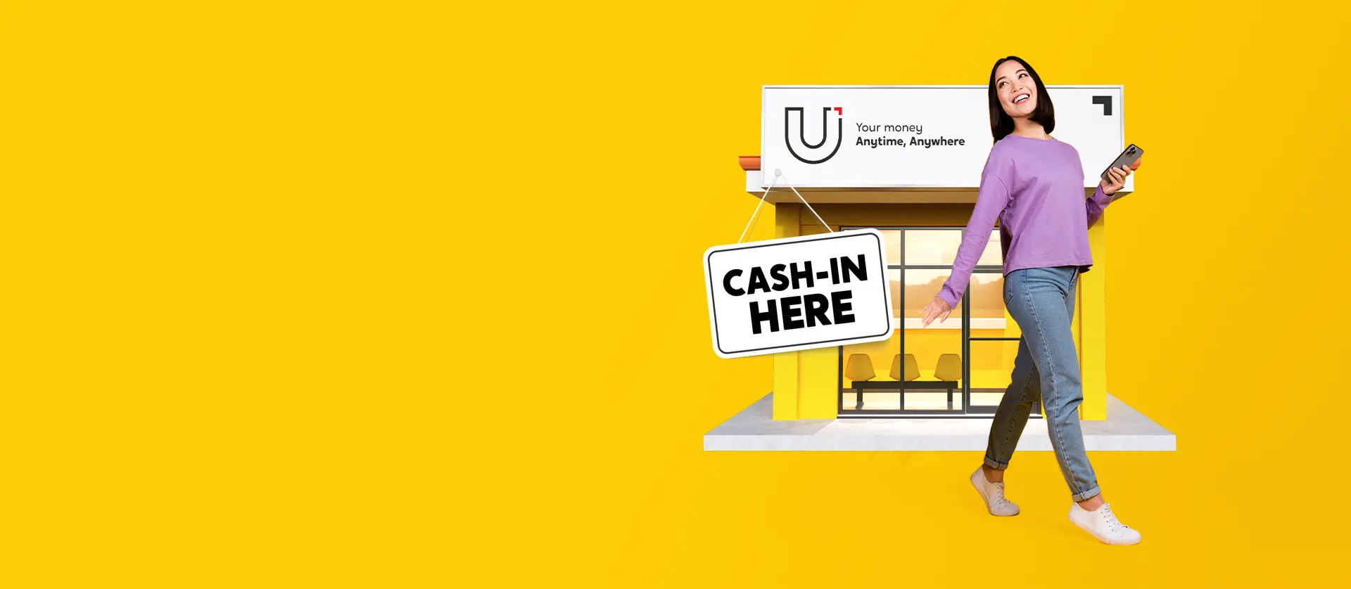 A woman holding a phone standing in front of a U Store with the sign Cash-in Here