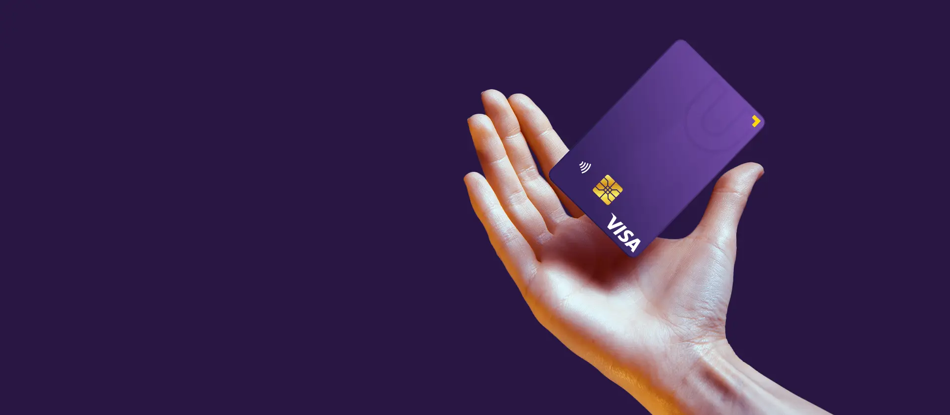 A hand holding a U Visa Prepaid Card